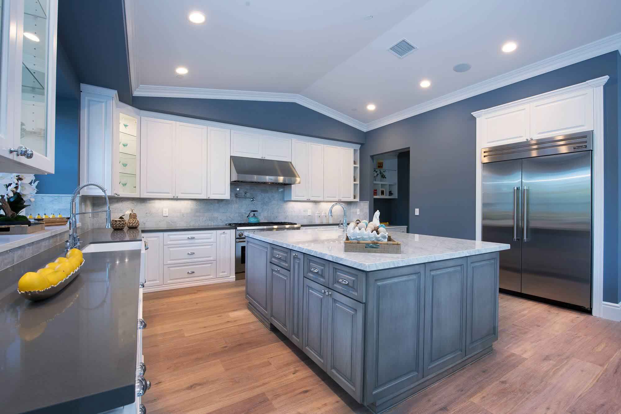 A massive kitchen island with gray cabinets, part of a kitchen remodel in Los Angeles, California by Los Angeles design-build firm A-List Builders.