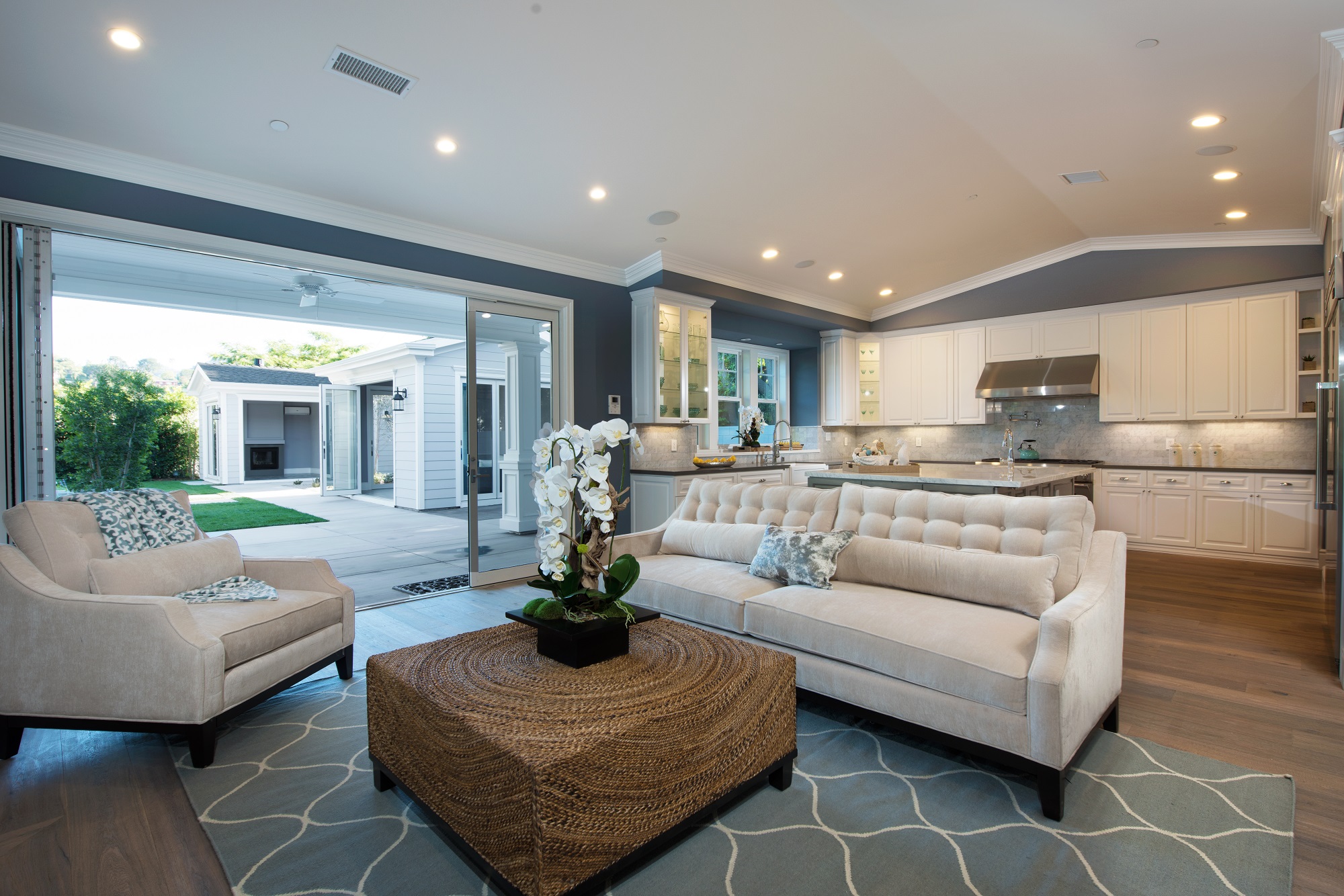 This spacious living room features a sliding glass wall to the back patio, part of a complete home remodel by Los Angeles design-build firm A-List Builders.
