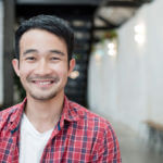 Smiling home remodeling contractor in Los Angeles, California wearing plaid.