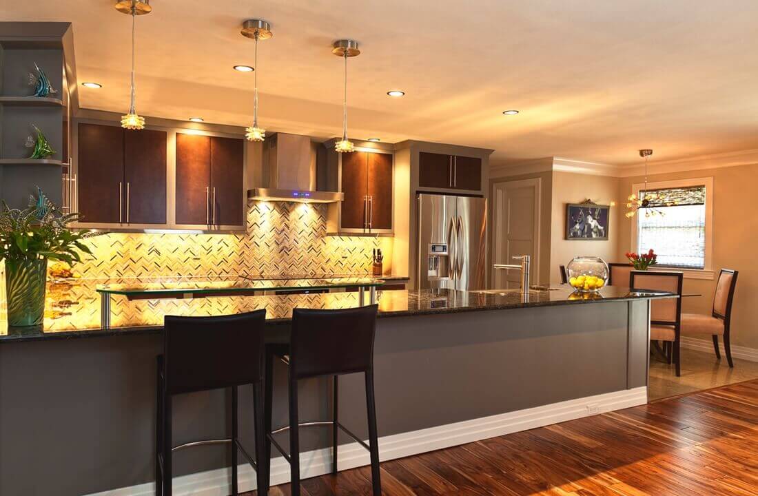 A long kitchen bar with plenty of counter space and room for seating, part of a kitchen remodel in Los Angeles, California by design-build firm A-List Builders.