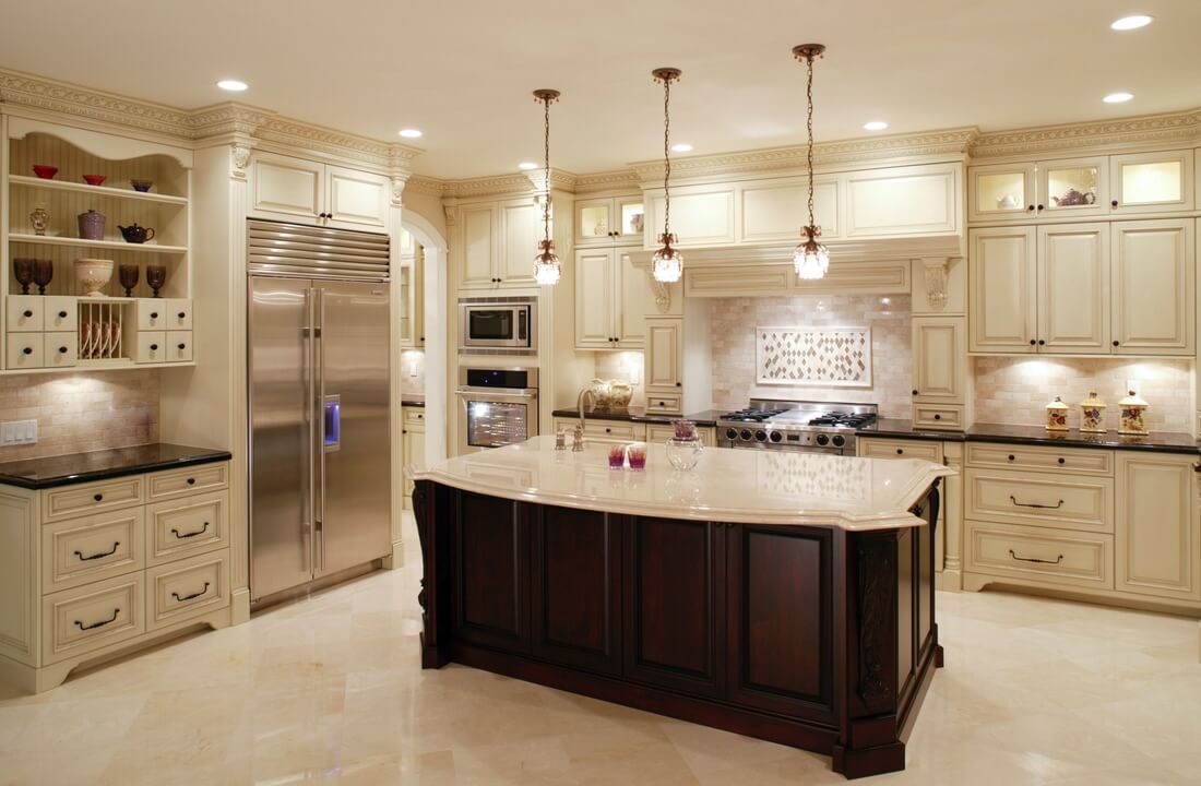 A spacious kitchen with warm white colors and a large island, part of a kitchen remodel in Los Angeles, California by design-build firm A-List Builders.