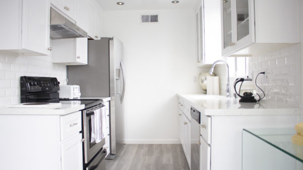 All white kitchen remodel with tile backsplash in West Hollywood, California home.