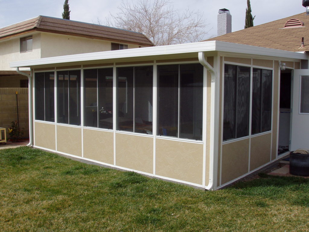 A wall of windows lets this patio enclosure double as a sun room; this enclosure was built by design-build firm A-List Builders, serving all of Los Angeles.