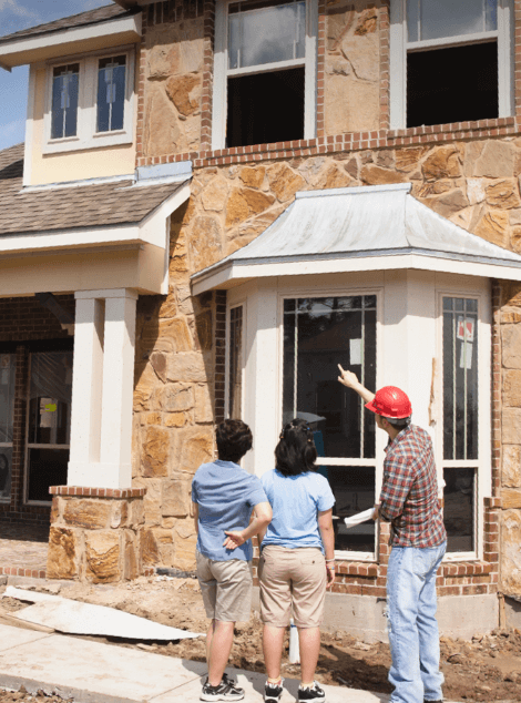 Contractor showing couple newly built exterior house