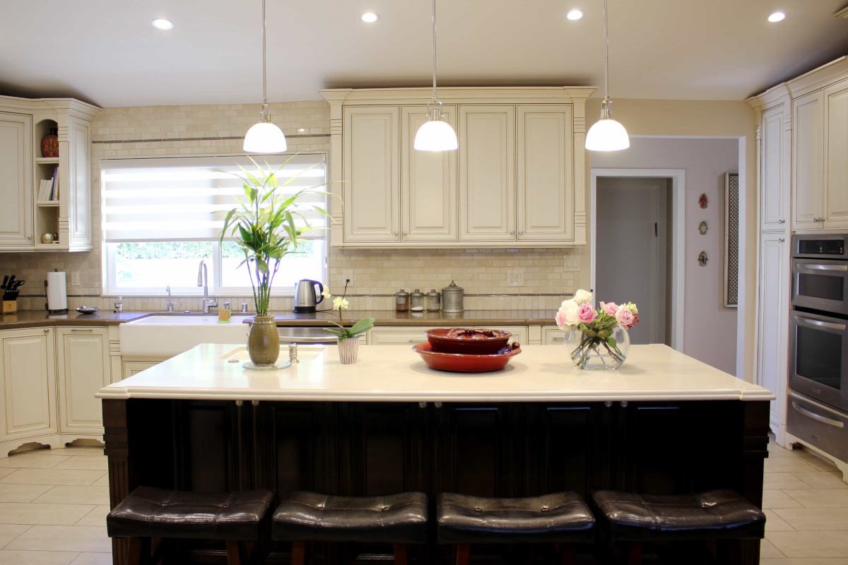 Bar seating with dark upholstery at a kitchen island, part of a home remodel in Sherman Oaks, CA by Los Angeles design-build firm A-List Builders.