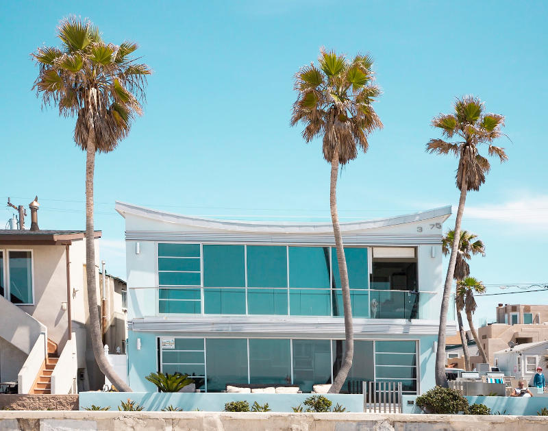 Modern Los Angeles coastal home with palm trees in front