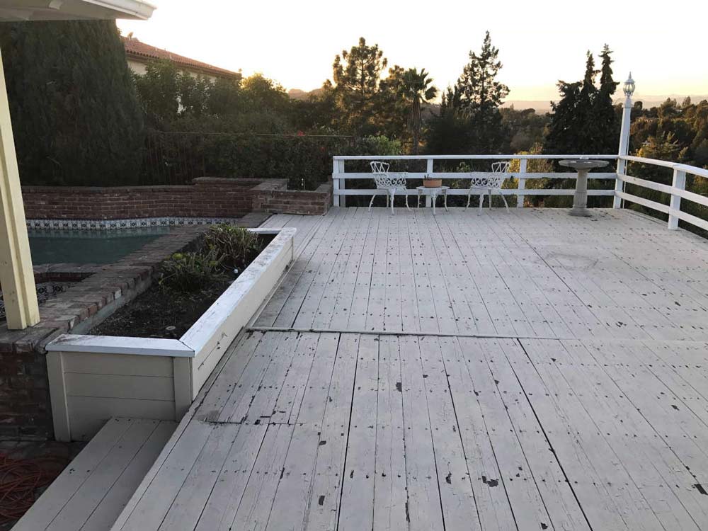 A before image of a spacious deck with a great view at a house in Studio City, CA prior to a complete remodel by Los Angeles design-build firm A-List Builders.