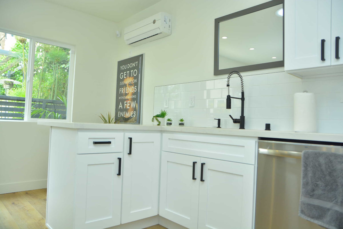 A light and airy kitchen and dining nook at a home in Beverlywood, CA, part of a complete home remodel by upscale Los Angeles design-build firm A-List Builders.