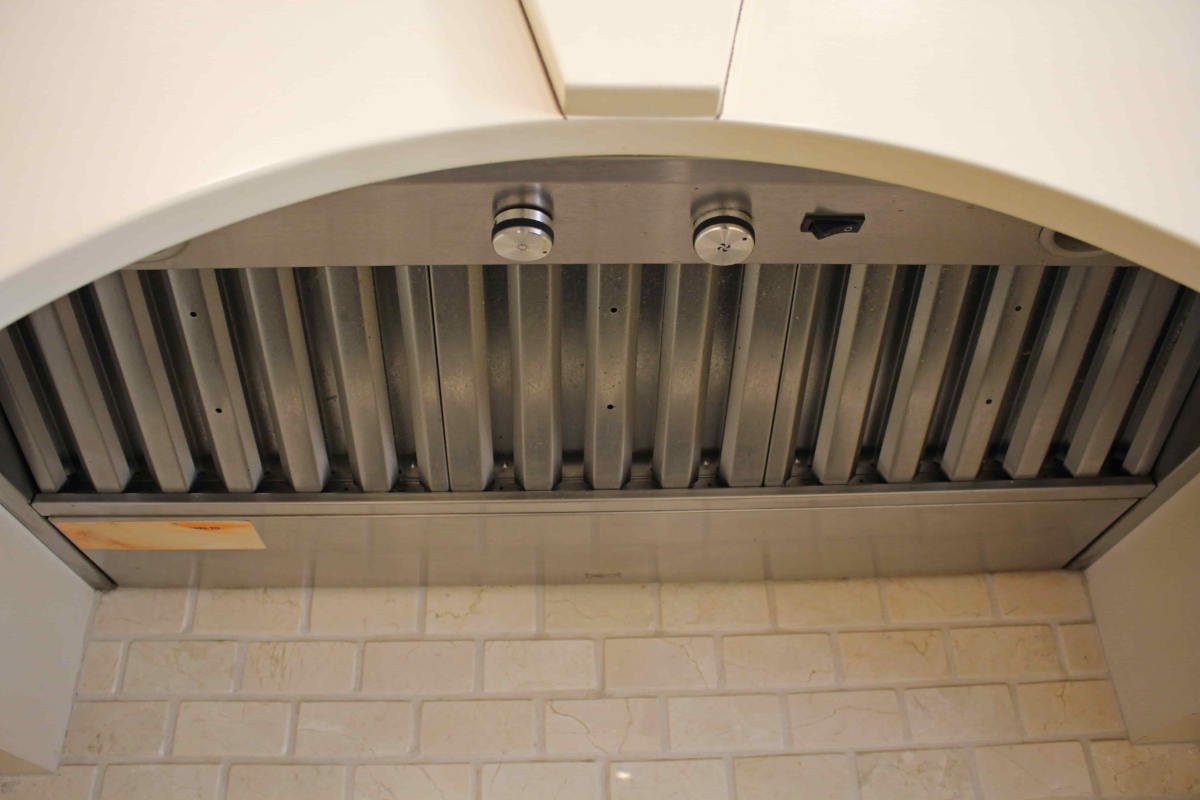 A modern fume hood over a range top at a house in Sherman Oaks, CA, part of a home remodel by upscale Los Angeles design-build firm A-List Builders.