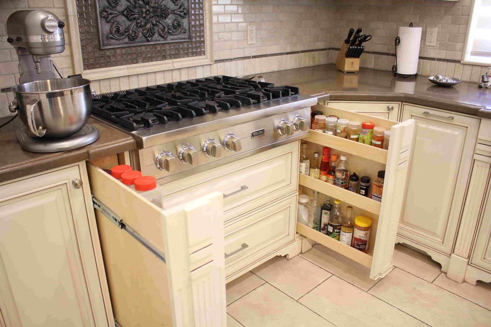 A new range top and pull-out spice drawer cabinets, part of a kitchen remodel on a home in Sherman Oaks, CA by Los Angeles design-build firm A-List Builders.