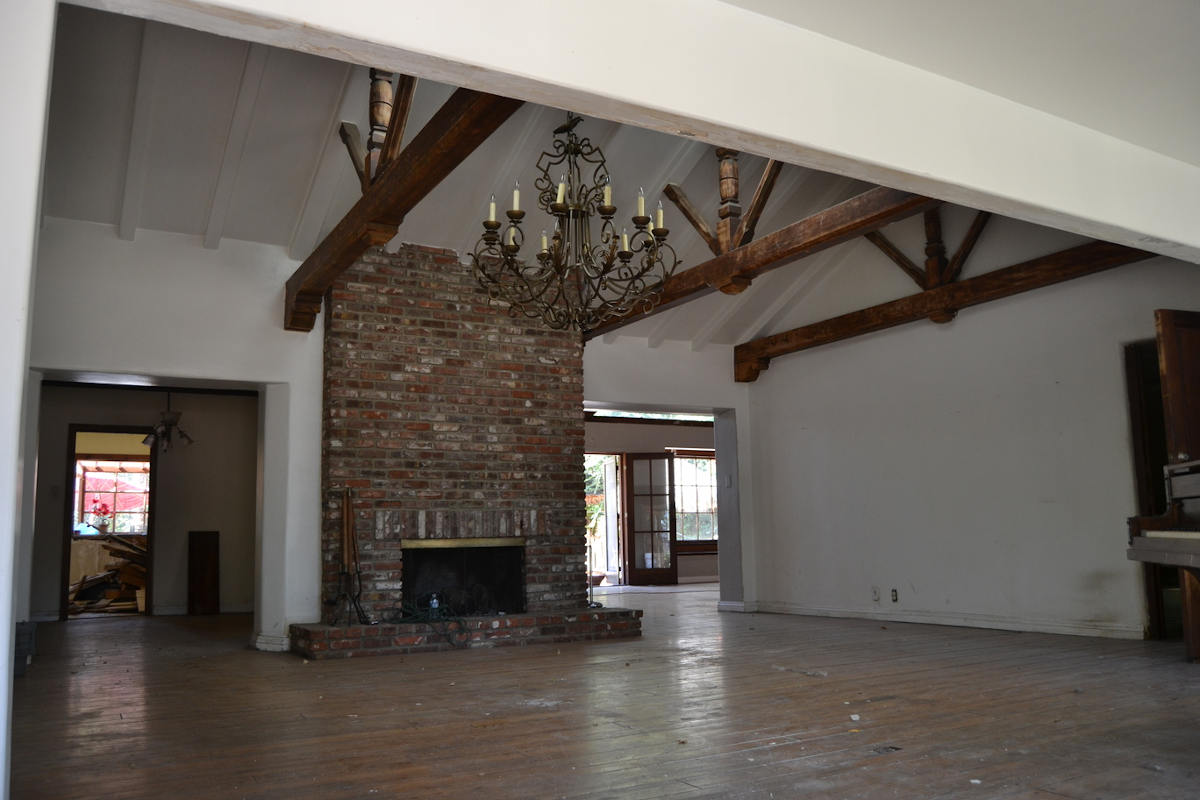 A before image of a large family room area with fireplace, in a home in Sherman Oaks, CA, prior to remodeling by Los Angeles design-build firm A-List Builders.