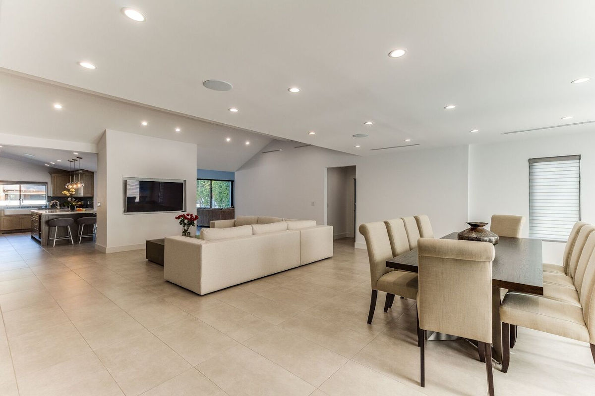 A cavernous family room and dining area in the center of a newly remodeled Sherman Oaks, CA home, completed by Los Angeles design-build firm A-List Builders.