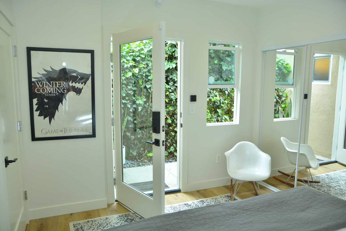 A front room and entryway with a modern decor, part of a home remodel in Beverlywood, CA by Los Angeles design-build firm A-List Builders.