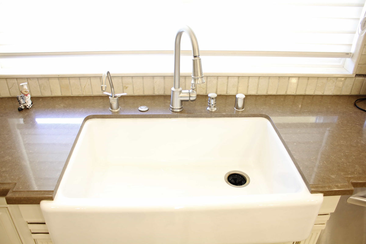 A new kitchen sink, counters, and fixtures at a home in Sherman Oaks, CA, part of a home remodel by Los Angeles design-build firm A-List Builders.