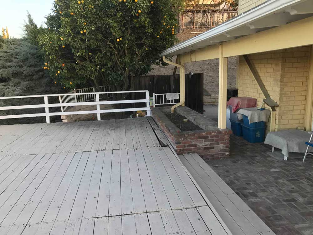 A before image of a stripped down deck at a home in Studio City, CA prior to remodeling by Los Angeles design-build firm A-List Builders.