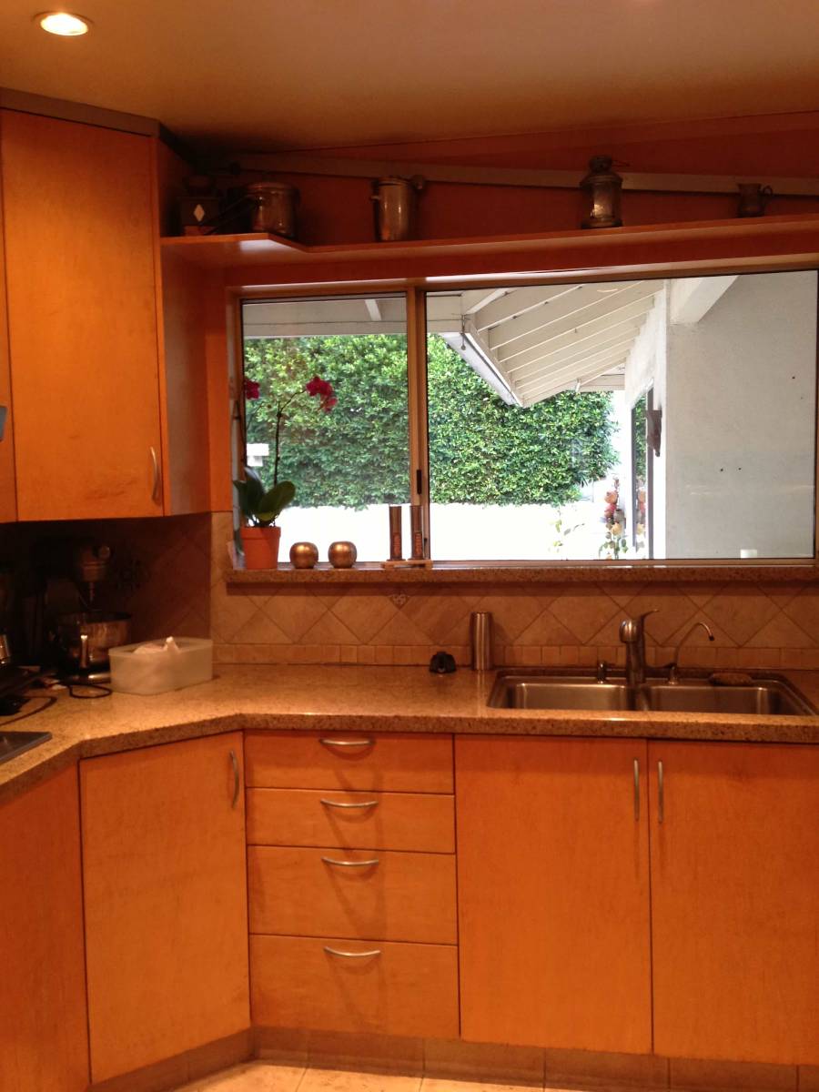 A sink, cabinet, and drawers in the kitchen of a Sherman Oaks, CA home, part of a home remodel by upscale Los Angeles design-build firm A-List Builders.