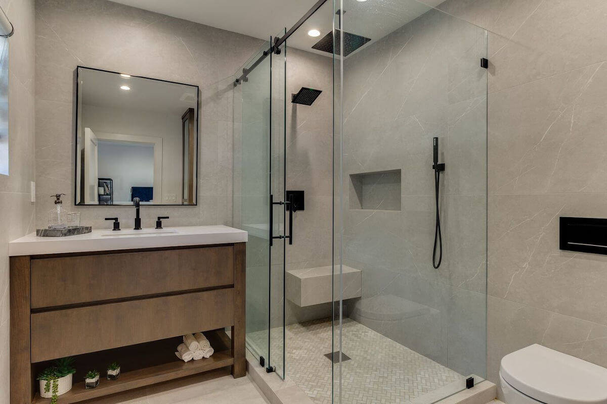 A new bathroom vanity of wood and stone, part of a home remodel at a house in Sherman Oaks, CA by Los Angeles design-build firm A-List Builders.