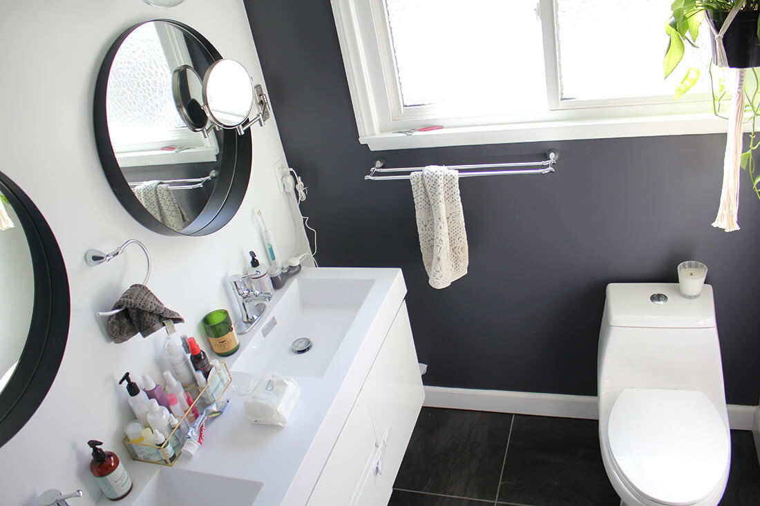 A bathroom vanity and toilet, featuring a gray, black, and white decor, part of a home remodel by upscale design-build firm A-List Builders, serving all of LA.