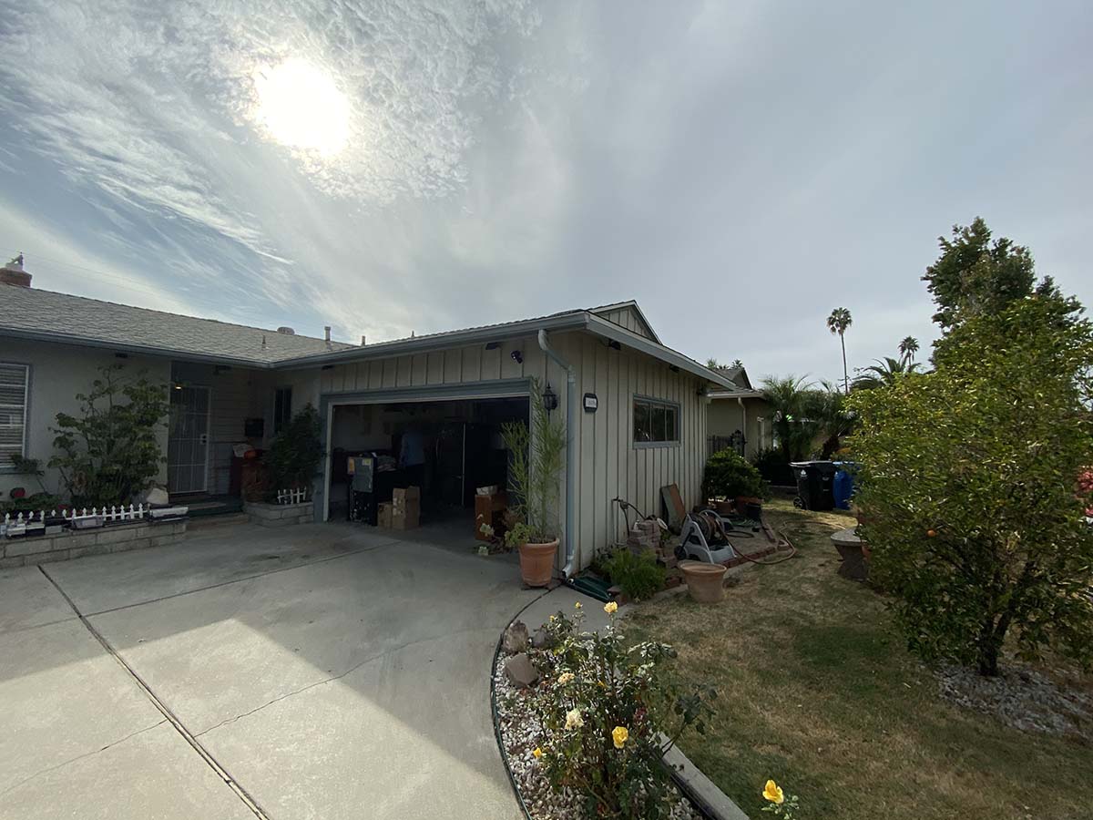 mage of a family home in Reseda, LA with garage door open before a garage remodel