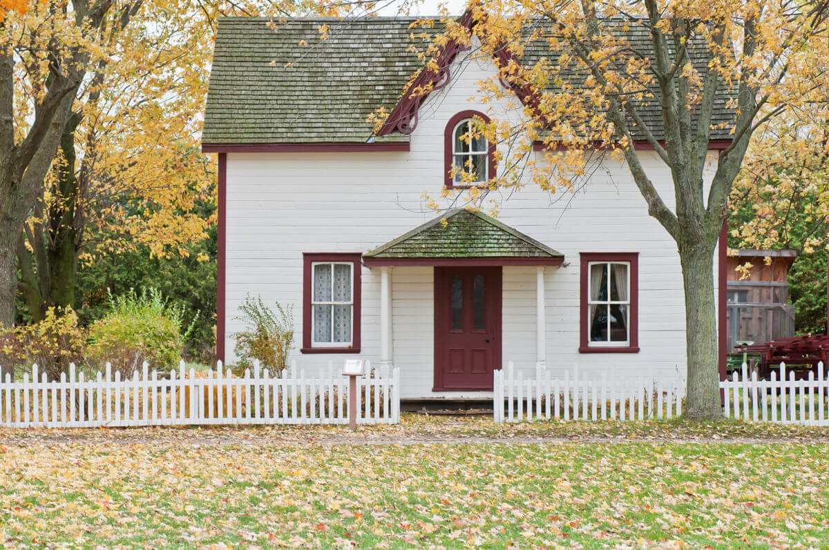 Small House With a White Picket Fence