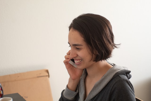 Woman on phone in her new garage home office in Los Angeles