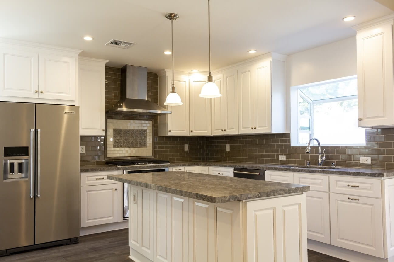 Stone counters and tile backsplashes, part of a complete home remodel in Burbank, California by design-build firm A-List Builders, serving greater Los Angeles.