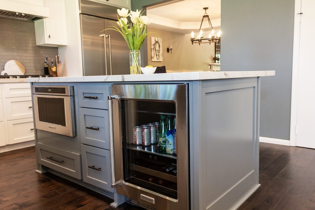 A beverage chiller sits in a kitchen island, part of a complete home remodel in Porter Ranch, California by Los Angeles design-build firm A-List Builders.