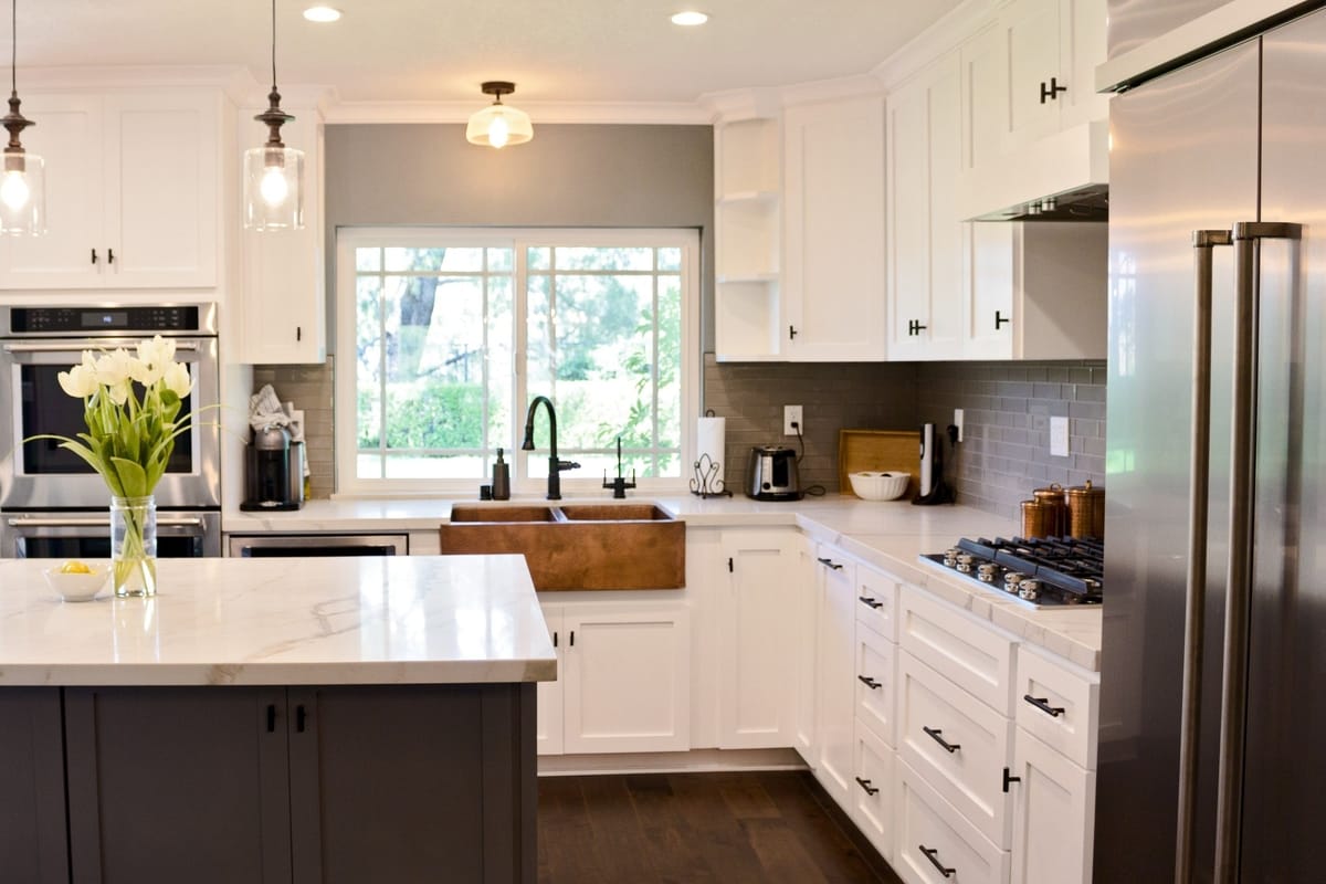 All-white kitchen decor with dark accents, part of a complete home remodel in Porter Ranch, California by design-build firm A-List Builders.