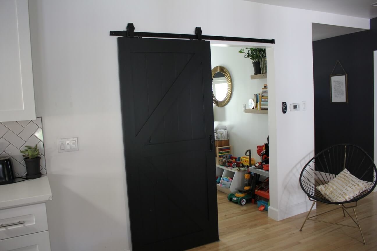 A sliding barn style door opens onto a playroom, part of an Encino, California home remodel by A-List Builders, serving all of Los Angeles.