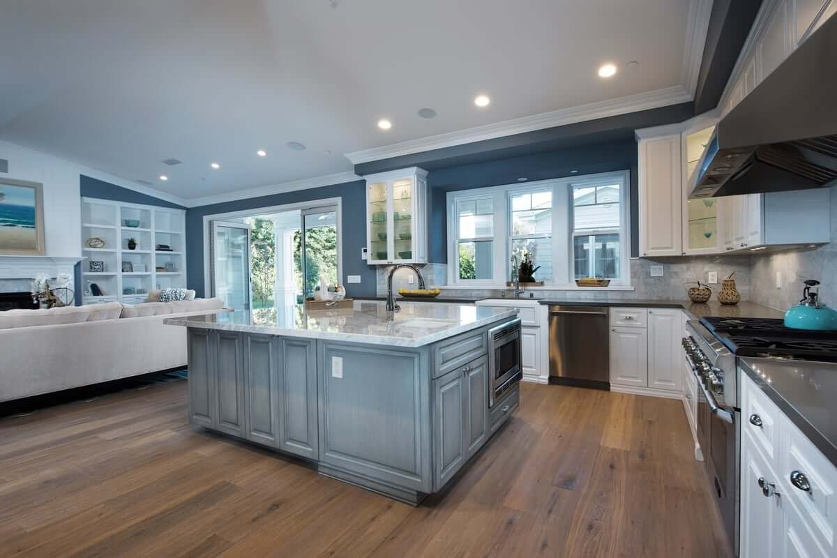 An elegant kitchen and living room form one large, open space, part of a complete home remodel by Los Angeles design-build firm A-List Builders.