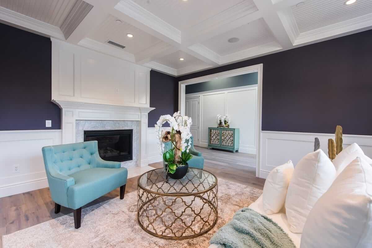 This sitting room features a fireplace and and elaborate ceiling, part of a home remodel by Los Angeles design-build firm A-List Builders.