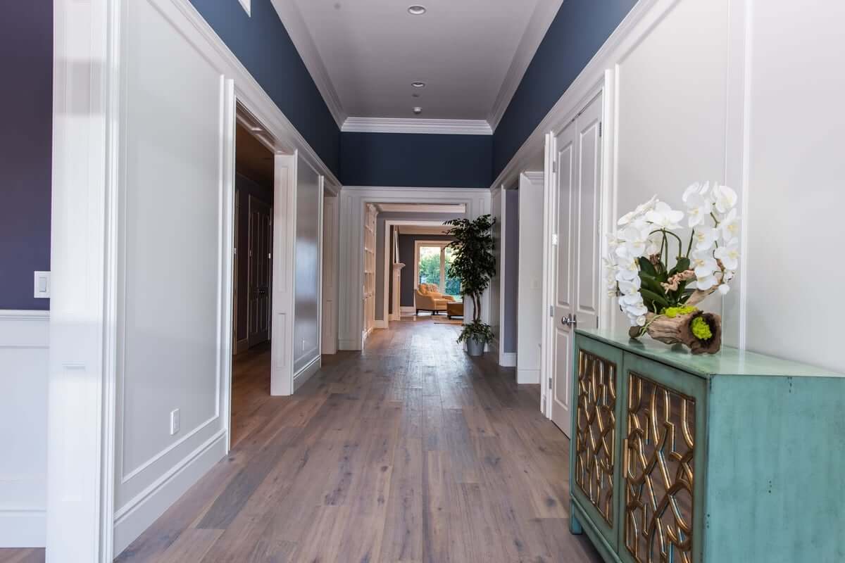 A wide main hallway with hardwood floors and a recessed ceiling, part of a home remodel by Los Angeles design-build firm A-List Builders.