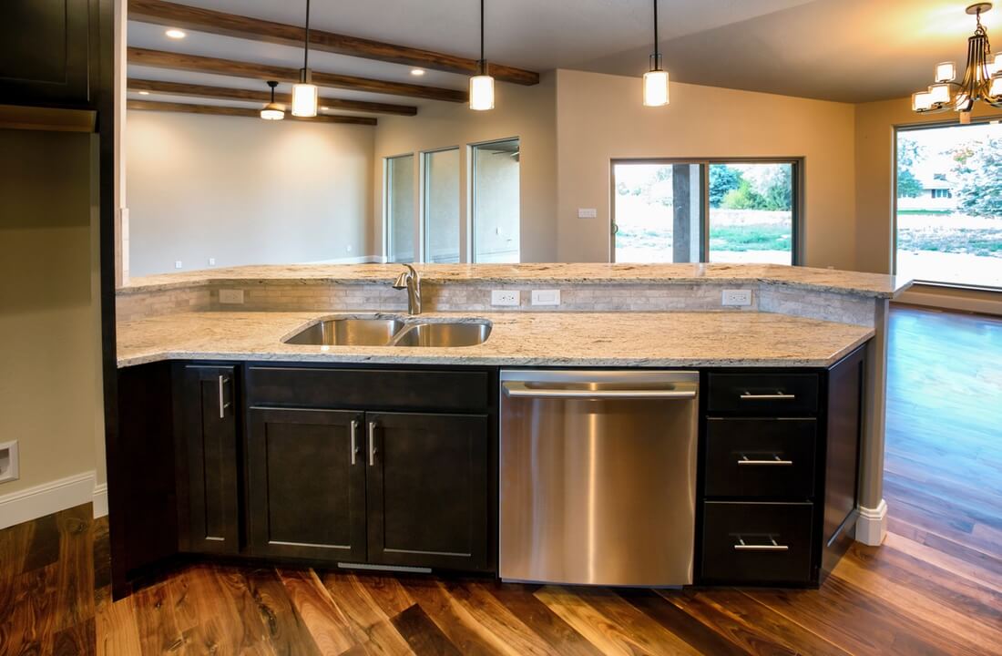 A kitchen sink looks out onto a family room, part of a kitchen remodel in Los Angeles, California by design-build firm A-List Builders, serving the LA area.