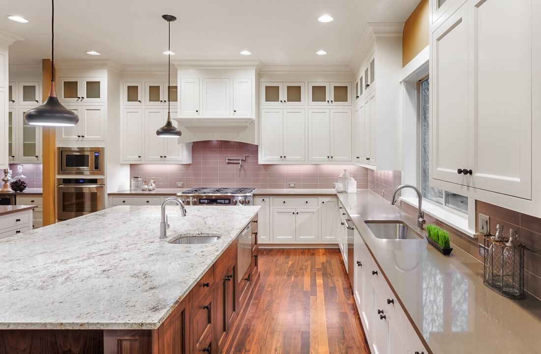 A massive kitchen dominates this kitchen remodel in Los Angeles, California by design-build firm A-List Builders, which serves the greater Los Angeles area.