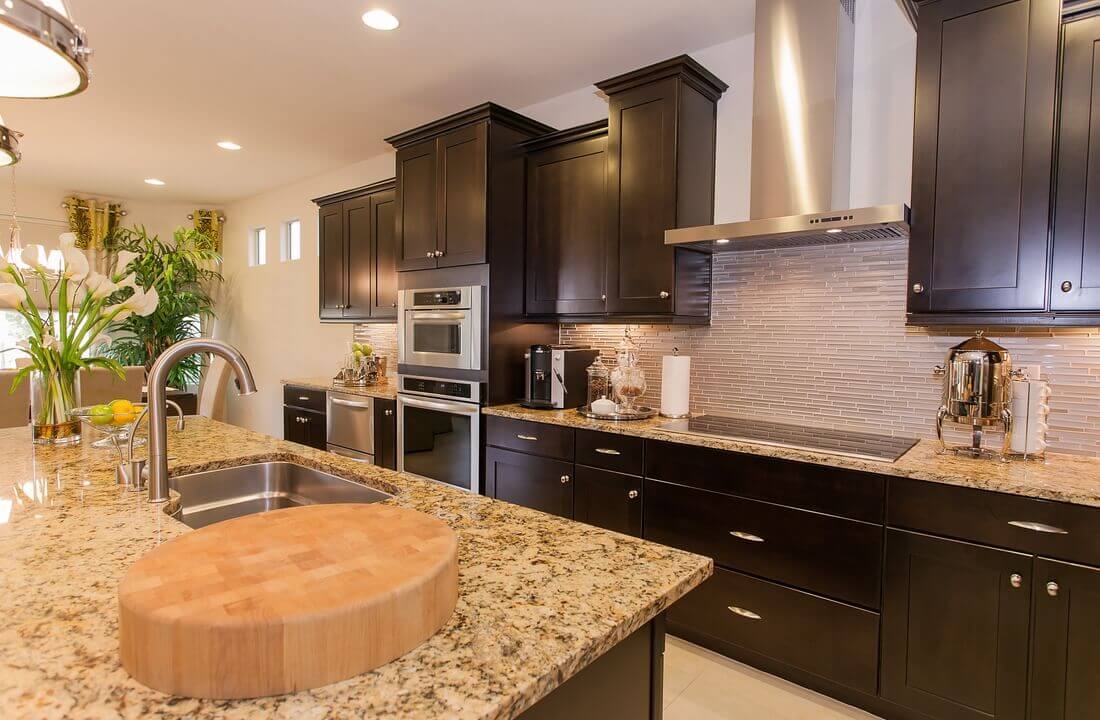 A luxurious kitchen island with granite countertops, part of a kitchen remodel in Los Angeles, California by Los Angeles design-build firm A-List Builders.