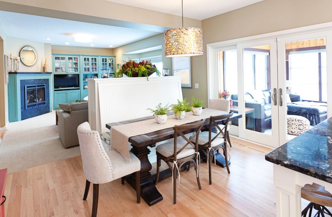 A rustic dining table with banquette seating on one side, part of a kitchen remodel in Los Angeles, California by design-build firm A-List Builders.