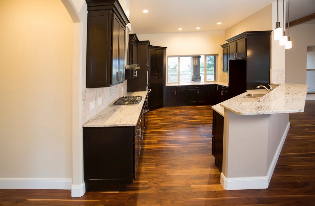 A cozy kitchen with dark cabinetry, part of a kitchen remodel in Los Angeles, California by design-build firm A-List Builders, which serves the LA area.